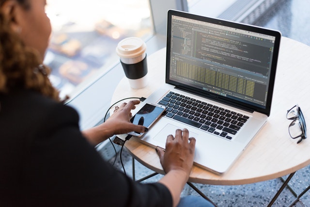 Woman coding on laptop