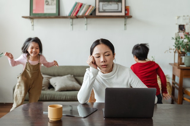 mother working at home with children