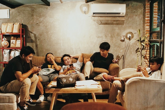 young men sitting on sofa