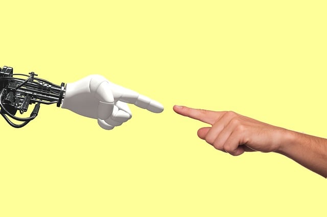 robot hand reaching human hand