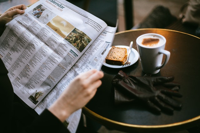 person reading newspapers