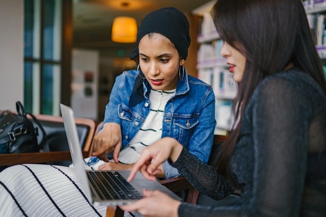 two women looking at screen